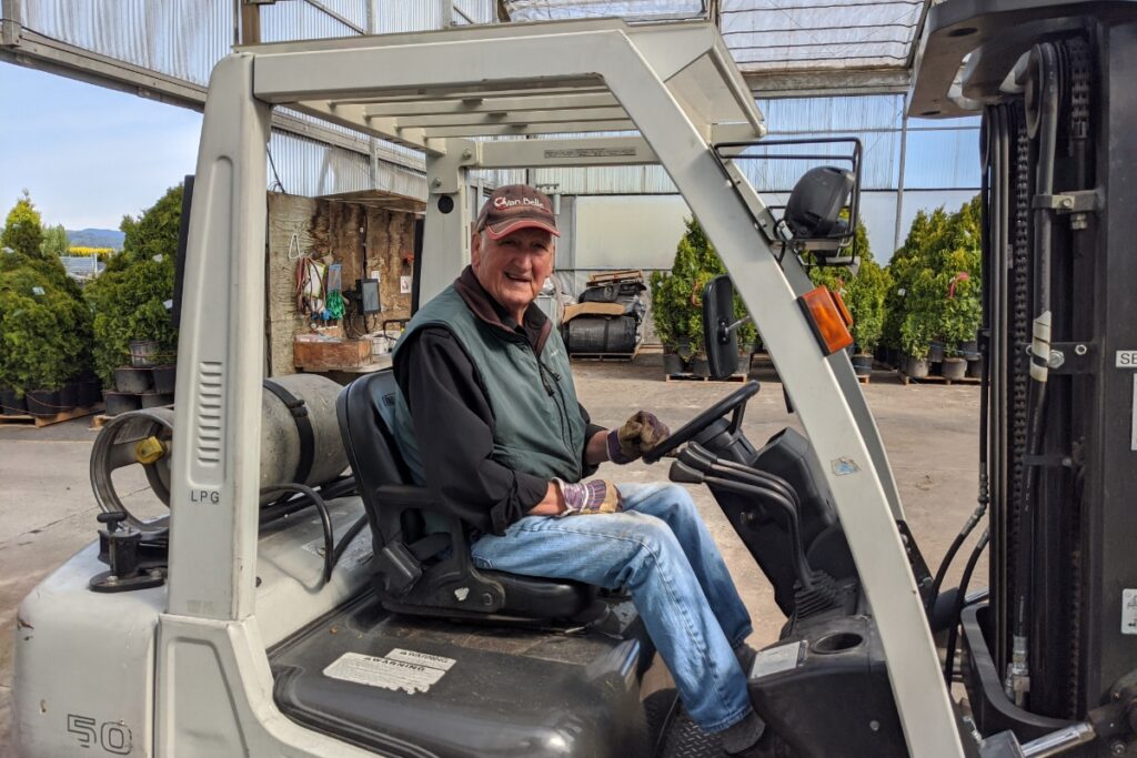 Bill Van Belle driving a forklift